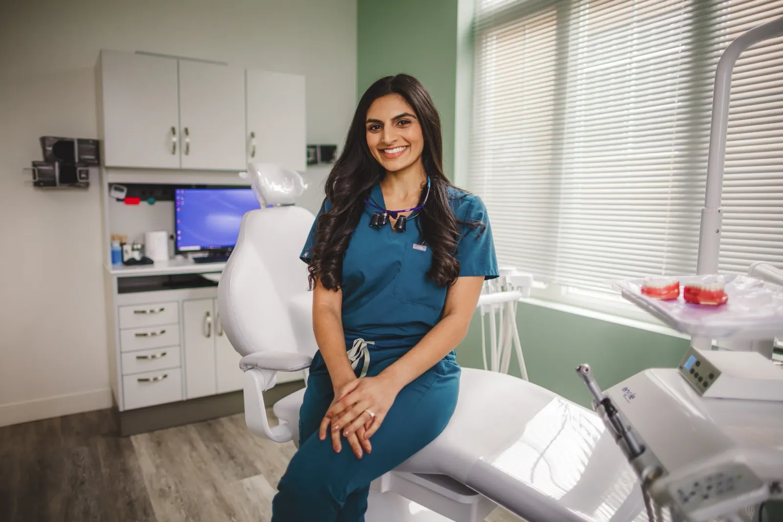 Dr. Anum Zaidi seated in a treatment room
