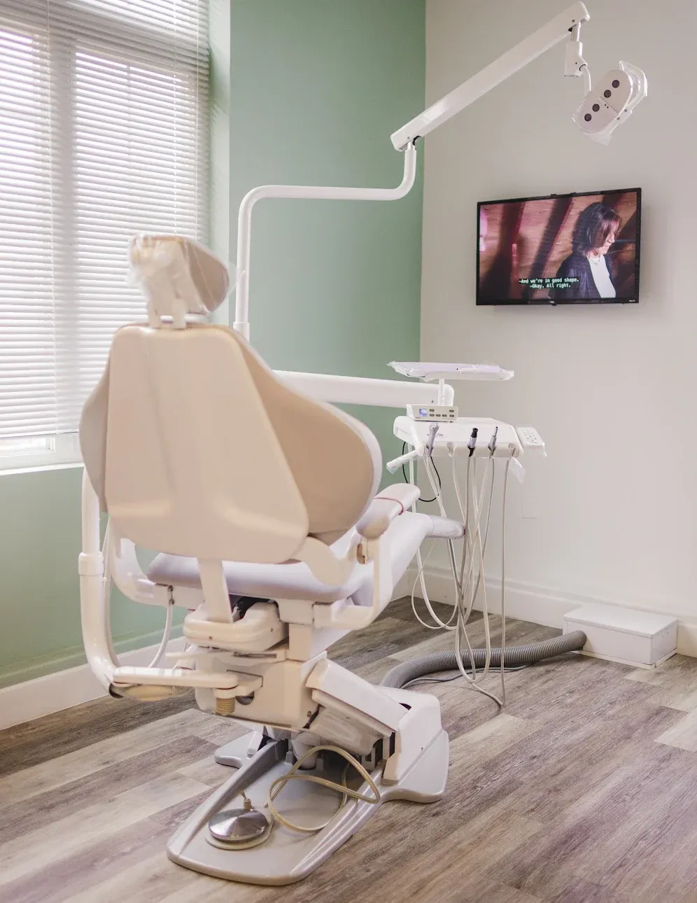 Treatment room with a dental chair and garden windows
