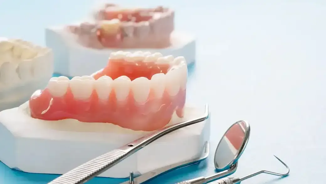Are Dentures Permanent? Lifespan, Care & Alternatives